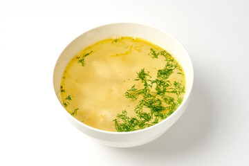 soup with dumplings in a white plate on a white background