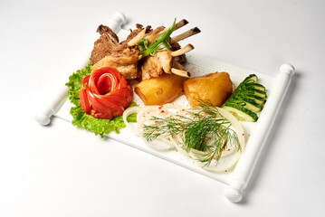 cauldron kebab with salad and onion, in a white plate, on a white background