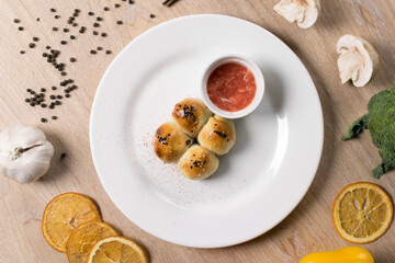 samosa with tomato sauce on a white plate