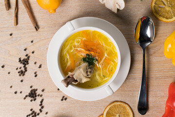 noodle soup with chicken leg in white plate