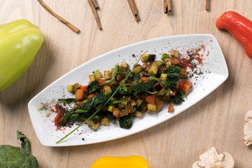 fried potatoes and eggplant with fresh tomato cucumbers and dandelion leaves