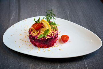 herring salad under a fur coat on a marble background