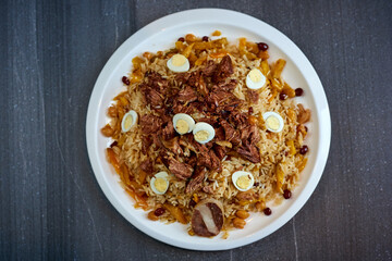 pilaf with meat and quail eggs on a marble background