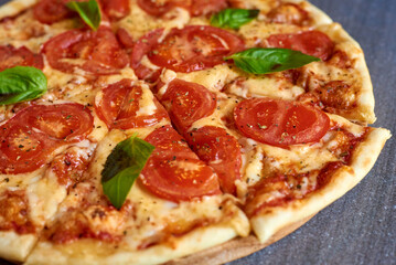 pizza with tomatoes and mint on a marble background