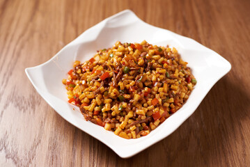tsomyan dish, in white plate, on wooden background