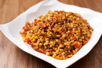 tsomyan dish, in white plate, on wooden background