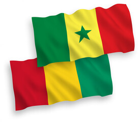 Obraz premium National vector fabric wave flags of Republic of Senegal and Guinea isolated on white background. 1 to 2 proportion.