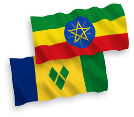 National vector fabric wave flags of Saint Vincent and the Grenadines and Ethiopia isolated on white background. 1 to 2 proportion.
