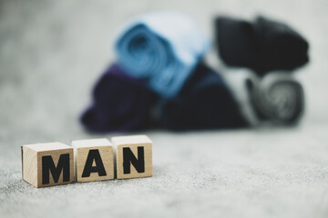 Text of MAN on a wood block and blur of man underwear background