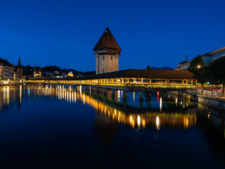 Image of Lucerne, Switzerland, with the famous historical wooden Chapel bridge, during twilight blue hour.