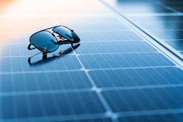Sunglasses on a solar panel with copy space