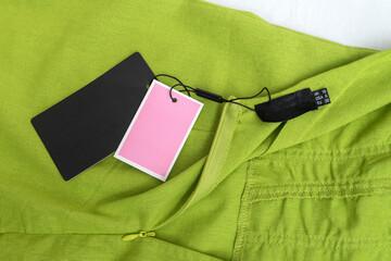 Light green dress or zippered skirt with empty black label. Summer clothes made natural fabric