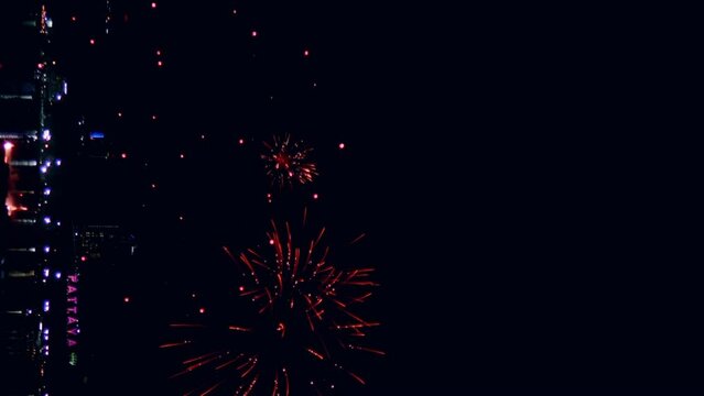 Loop seamless of real fireworks lights up the sky with dazzling displays in the night sky. Vertical Footage
