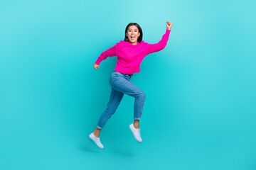 Fototapeta na wymiar Full length photo of excited shiny girl dressed pink pullover jumping high running fast isolated teal color background