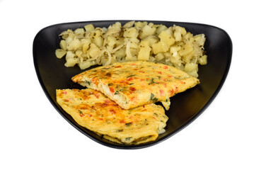 Mexican omelet with potato on black plate isolated on white background top view