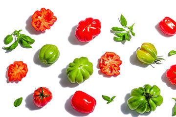 Green and red ribbed tomatoes isolated on white background. American or Florentine variety