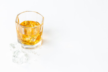 Glass of whiskey or brandy with ice. Strong alcohol background