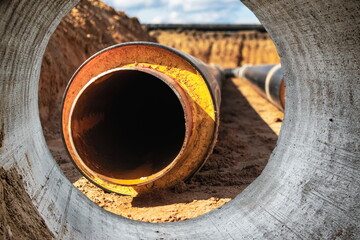 Insulated pipe. Large metal pipes with a plastic sheath at a construction site. Modern pipeline for supplying hot water and heating to a residential area. Close-up.