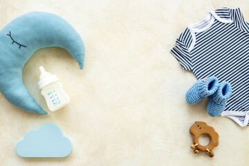 Baby cotton bodysuit with bottle of milk and toys