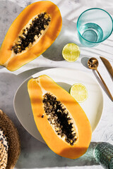 Ripe and freshly cut papaya with its seeds and white background. Fresh and tropical fruit