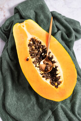Ripe and freshly cut papaya with its seeds and white background. Fresh and tropical fruit