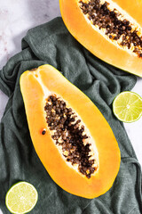 Ripe and freshly cut papaya with its seeds and white background. Fresh and tropical fruit