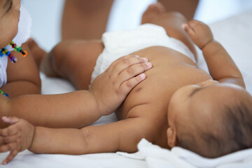 Obraz na płótnie Canvas close up kid hands touching a newborn baby on bed