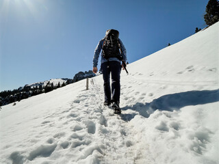 Fototapeta na wymiar Lonely Man hike to the peak of the Chiemgau Kampenwand mountain