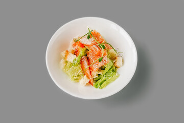 Caesar Salad on gray background. Front view.