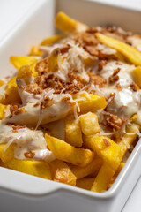 close-up of potatoes with meat sauce in a white bowl