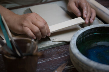 Hand close up of Young Asian female in the pottery workshop 