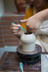 Hand close up of Young Asian female in the pottery workshop 