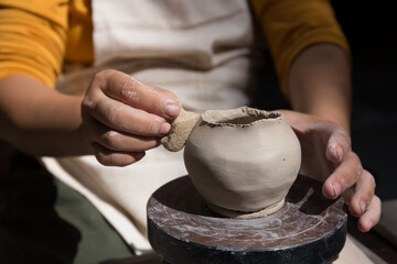 Hand close up of Young Asian female in the pottery workshop 