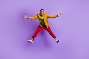 Fototapeta na wymiar Full length photo of overjoyed cheerful person jumping falling have good mood isolated on violet color background
