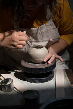Hand close up of Young Asian female in the pottery workshop 