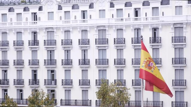 Spain flag in slow motion, blowing in the wind. Flag in Madrid museum. Spanish buildings in the background. Beautiful flag
