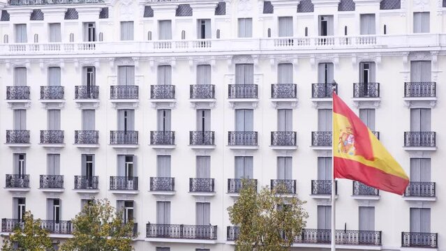 Spain flag blowing in the wind. Slow motion flag in Madrid museum. Spanish buildings in the background. Beautiful flag
