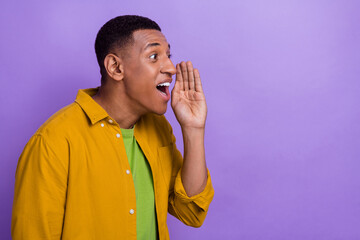 Photo of handsome positive impressed guy dressed yellow shirt hand near mouth look empty space isolated on pastel color background