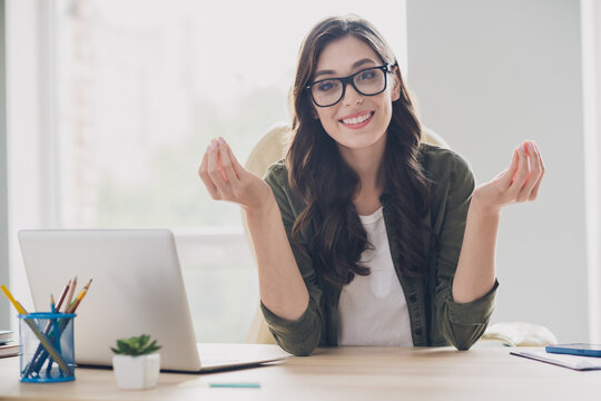 Photo of smiling happy lady assistant wear glasses talking having interview indoors workstation workshop