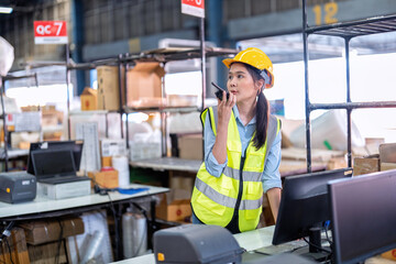 Worker working in large depot storage warehouse hold radio walkie talkie to team at cashier counter