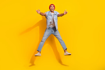 Fototapeta na wymiar Full length photo of excited charming man wear jeans outfit jumping high ready hug you isolated yellow color background