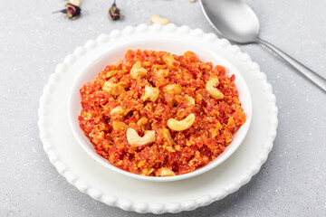 Gajar ka halva is a traditional North Indian dessert made with freshly grated carrots, desi ghee, milk and sugar, delicately scented with cardamom and garnished with chopped nuts.