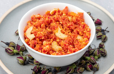 Fototapeta na wymiar Gajar ka halwa is a delicious carrot-based sweet dessert pudding from Punjab, India. Served in winters, weddings and festivals.