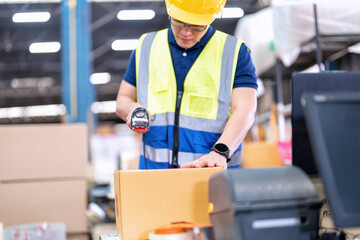 Worker in large depot storage warehouse use adhesive tape prepare packing box at cashier counter