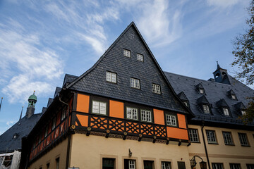 Fototapeta na wymiar Wernigerode, Saxony-Anhalt, Germany, 29 October 2022: Historic townhall or Rathaus in Market Square, vintage colored timber framed building Fachwerkbau, half-timbered home at sunny autumn day