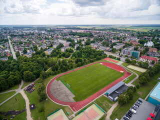 Fototapeta na wymiar Radviliskis City in Lithuania. Sport Stadium and Cityscape, Skyline in Background. Aerial, Architecture.