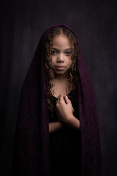 classic painterly renaissance portrait of young girl with purple veil on curly hair