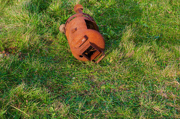 Old rusted wood burner discarded on the grass verge at Tyrella beach County Down Northern Ireland