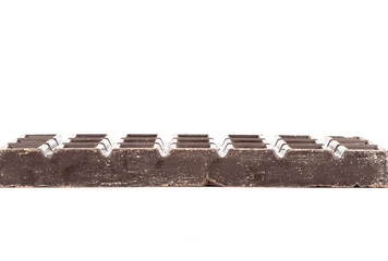 Side view of a dark chocolate bar on a white background.
