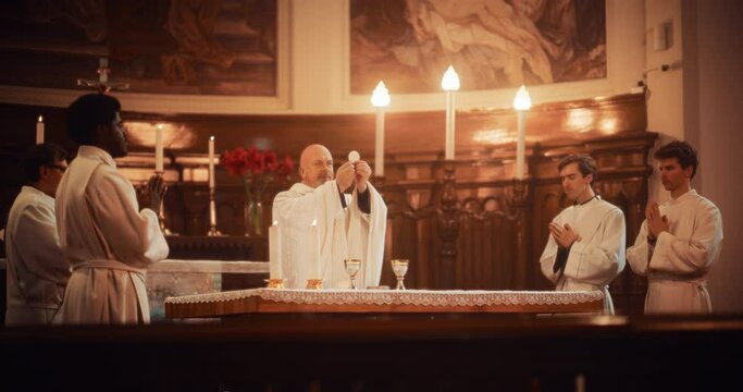 The Eucharist In Grand Church: Ministers of Christian Faith lead The Ceremony that Involves Sharing Bread And Wine In Honor of Jesus Christ. Holy Communion, Divine Mass, Lord's Supper at the Altar